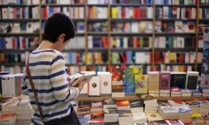 Woman reading in books in a bookshop